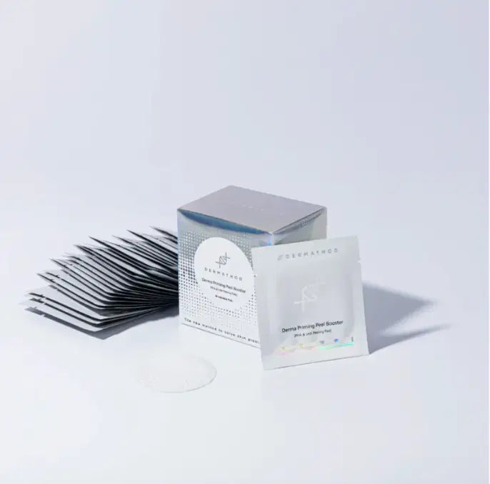 Eyelash extensions and a box with a brand label on a white background