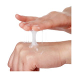 Hand applying a white cream or gel to another hand on a white background